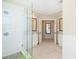 Hallway to bathrooms featuring herringbone tile floors and vanities with granite countertops at 720 Lakeglen Dr, Suwanee, GA 30024