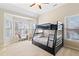 This bedroom features a bunk bed, bay window, and carpeted floor at 720 Lakeglen Dr, Suwanee, GA 30024