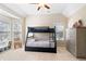 Bedroom showcasing a bunk bed, sitting area, and a dresser with lots of storage at 720 Lakeglen Dr, Suwanee, GA 30024