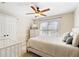 Cozy bedroom with natural light, ceiling fan, bed and a closet with dresser at 720 Lakeglen Dr, Suwanee, GA 30024