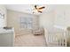 Bright Bedroom with ceiling fan, white crib, chair, and changing table offering a cozy, nurturing space at 720 Lakeglen Dr, Suwanee, GA 30024