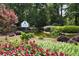 Picturesque community entrance to Grand Cascades with water feature and landscaping at 720 Lakeglen Dr, Suwanee, GA 30024