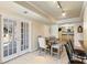 Sunlit dining area features tile floors, a wooden table with seating for six, and access to the patio at 720 Lakeglen Dr, Suwanee, GA 30024
