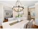 Bright dining room featuring a modern chandelier, neutral tones, and wood floors at 720 Lakeglen Dr, Suwanee, GA 30024