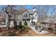 Rear exterior of the house with a deck, stairs, and well-maintained landscaping at 720 Lakeglen Dr, Suwanee, GA 30024