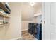 Laundry room with shelving and side-by-side washer and dryer at 720 Lakeglen Dr, Suwanee, GA 30024