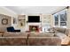 Relaxing living room featuring built-in shelving and a cozy fireplace at 720 Lakeglen Dr, Suwanee, GA 30024
