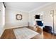 Spacious living room with hardwood floors, decorative rug, and a view into the Gathering room at 720 Lakeglen Dr, Suwanee, GA 30024
