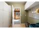 Mud room includes cabinetry, access to back yard and a number plate reading '336' at 720 Lakeglen Dr, Suwanee, GA 30024