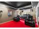 Home theater room with cozy seating, projector and dark, tiered ceilings at 720 Lakeglen Dr, Suwanee, GA 30024
