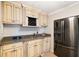 Stylish wet bar with granite countertops, stainless steel appliances, custom cabinets, and built-in wine rack at 720 Lakeglen Dr, Suwanee, GA 30024