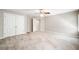 Spacious bedroom featuring carpet, ceiling fan, and closet with double doors at 8215 Majors Mill Dr, Cumming, GA 30041