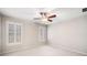 A bright bedroom featuring a ceiling fan and windows with white shutters at 8215 Majors Mill Dr, Cumming, GA 30041