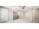 Upper level bonus room with carpeted floors and dark wood railing at 8215 Majors Mill Dr, Cumming, GA 30041