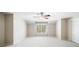 Upstairs bonus room featuring neutral carpet and shuttered windows overlooking backyard at 8215 Majors Mill Dr, Cumming, GA 30041