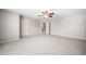 Large bonus room featuring neutral carpet and doorways to bedrooms or storage at 8215 Majors Mill Dr, Cumming, GA 30041
