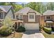 Charming two-story home featuring a stone facade, well-manicured landscaping, and a spacious two car garage at 8215 Majors Mill Dr, Cumming, GA 30041