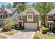 Beautiful home with stone accents, a two-car garage, and well-manicured front yard at 8215 Majors Mill Dr, Cumming, GA 30041