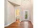 Bright foyer with hardwood floors, high ceilings and decorative glass front door and half bath at 8215 Majors Mill Dr, Cumming, GA 30041