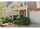 Charming front porch with stately columns and flowering shrubs enhancing curb appeal at 8215 Majors Mill Dr, Cumming, GA 30041