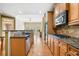 Gourmet kitchen featuring granite countertops, stainless steel appliances, and wood cabinets at 8215 Majors Mill Dr, Cumming, GA 30041