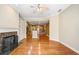 Spacious living room with hardwood floors, fireplace, and open view into the kitchen area at 8215 Majors Mill Dr, Cumming, GA 30041