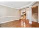 Spacious living room with hardwood floors, open layout, and staircase access at 8215 Majors Mill Dr, Cumming, GA 30041