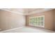 Spacious main bedroom with a trey ceiling, large window, and plush carpet at 8215 Majors Mill Dr, Cumming, GA 30041