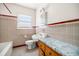 Bathroom with tiled walls, marble countertop, and vintage fixtures at 1715 E Clifton Ne Rd, Atlanta, GA 30307