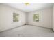 Cozy bedroom featuring neutral carpet and natural light from two windows with tree views at 1715 E Clifton Ne Rd, Atlanta, GA 30307