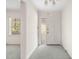 Bright entryway featuring neutral carpet, a chandelier, and a front door with a sidelight window at 1715 E Clifton Ne Rd, Atlanta, GA 30307
