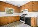 Kitchen with wood cabinets, laminate countertops, and a window that provides natural light at 1715 E Clifton Ne Rd, Atlanta, GA 30307