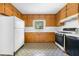 Functional kitchen with wood cabinets, updated appliances, and a window above the sink at 1715 E Clifton Ne Rd, Atlanta, GA 30307