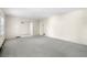 Spacious living room featuring neutral carpet, a window, and an open doorway to another room at 1715 E Clifton Ne Rd, Atlanta, GA 30307