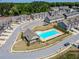 A captivating aerial view of community amenities featuring a sparkling pool and clubhouse amid landscaped grounds at 262 Quay Dr, Lawrenceville, GA 30044