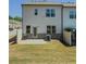 A home exterior showcases a well-maintained backyard with a cozy patio, grassy area, and partial fence at 262 Quay Dr, Lawrenceville, GA 30044