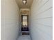 Inviting entryway featuring a dark wood door with glass insert and sidelights, and light colored siding at 262 Quay Dr, Lawrenceville, GA 30044