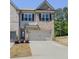 Charming two-story townhome featuring a brick facade, a two-car garage, and a well-manicured lawn at 262 Quay Dr, Lawrenceville, GA 30044