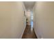 Bright hallway with hardwood floors, neutral paint, and access to other rooms in the home at 262 Quay Dr, Lawrenceville, GA 30044