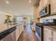 Well-equipped kitchen with granite counters, stainless appliances, and hardwood floors at 262 Quay Dr, Lawrenceville, GA 30044