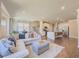 Open concept living room and kitchen featuring modern appliances, hardwood floors, and a comfortable sectional sofa at 262 Quay Dr, Lawrenceville, GA 30044