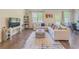 Spacious living area with large sectional sofa and modern decor, complemented by natural light and open floor plan at 262 Quay Dr, Lawrenceville, GA 30044