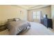 Serene main bedroom with a tray ceiling, soft carpet, and a large window, offering a peaceful retreat at 262 Quay Dr, Lawrenceville, GA 30044