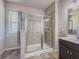 Modern bathroom featuring a glass-enclosed shower, neutral tile, and contemporary fixtures for a sleek design at 262 Quay Dr, Lawrenceville, GA 30044
