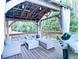 Relaxing back deck with a grill, seating, outdoor curtains, and string lights at 2818 Willowstone Dr, Duluth, GA 30096