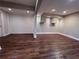 Finished basement with dark-stained wood-look floors, recessed lighting, and textured accent wall at 2818 Willowstone Dr, Duluth, GA 30096