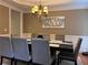 Dining area featuring an ornate light fixture, seating for eight, and neutral paint at 2818 Willowstone Dr, Duluth, GA 30096