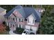 Aerial view of a brick house with black shutters, a two-car garage, and manicured landscaping at 2818 Willowstone Dr, Duluth, GA 30096