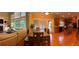 Panoramic view of a living room, dining table, and kitchen with hardwood floors and large windows at 2818 Willowstone Dr, Duluth, GA 30096