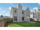 Home's backyard with a grassy lawn and a wooden fence at 400 Mirramont Ln, Woodstock, GA 30189
